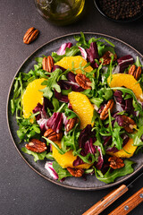 Arugula, orange and pecan salad. Radicchio salad on brown background - 752525678