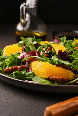 Arugula, orange and pecan salad. Radicchio salad on brown background - 752525825