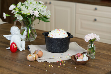 Easter cake with white glaze in a cast iron bowl in a bright kitchen