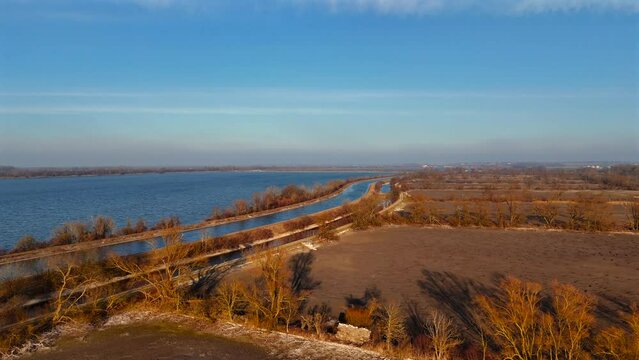 Ismaninger Speichersee Munchen, Bayern, Deutschland. Reservoir and water channels in spring during sunny weather. Water storage system serves as stage in biological treatment of Munich waste water. 