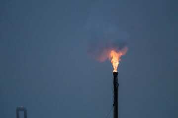 Flare flaming up at a refinery.