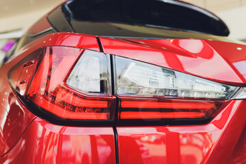 Detail on the rear light of a red car.