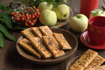 Cookies in the form of a rectangle with sesame seeds on a wooden plate