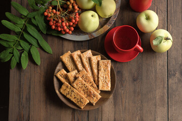Cookies in the form of a rectangle with sesame seeds on a wooden plate