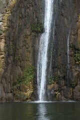 Fototapeta na wymiar Waterfall cascade on mountain rocks 