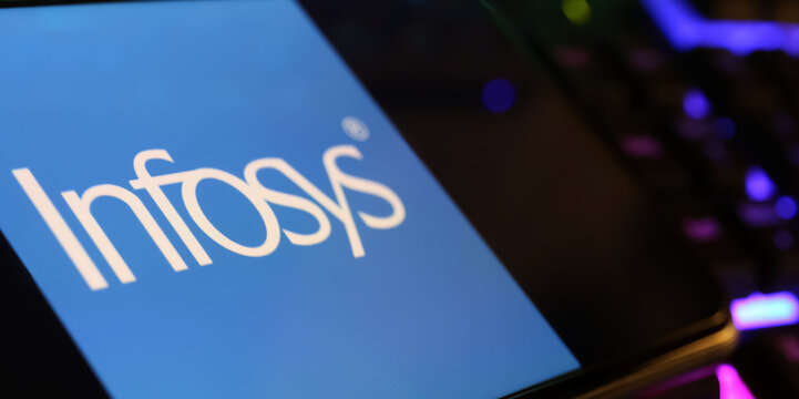 Viersen, Germany - March 1. 2024: Closeup of smartphone screen with logo lettering of Infosys on computer keyboard