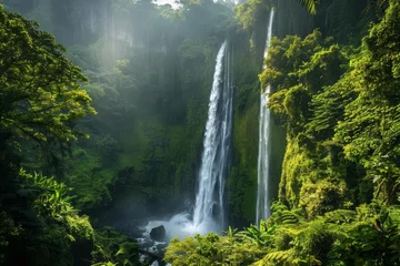 Schilderijen op glas Majestic waterfall in a lush tropical forest © Bijac