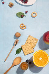 Corn flakes, fruits and berries on a blue background in sunlight