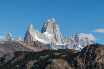 Mount Fitz Roy also known as Cerro Chalten, Cerro Fitz Roy, or Monte Fitz Roy close up on a sunny day with blue sky. It is a mountain in Patagonia, on the border between Argentina and Chile