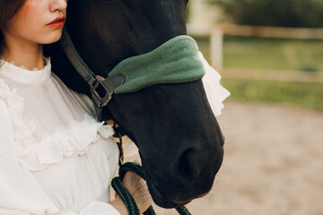 Woman portrait hugs her horse bridle at outdoors ranch - 752556452