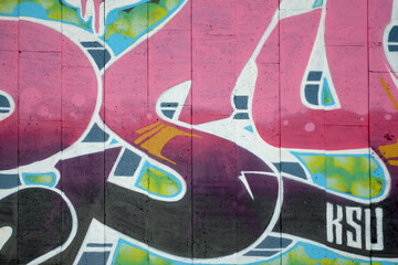 Colorful background of graffiti painting artwork with bright aerosol outlines on wall. Old school...