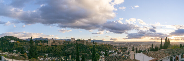 Fototapeta na wymiar Panorama of fortress of Alhambra on a hill top seen from the quarter Albaicin with mountains of Sierra Nevada in background, Granada, Andalusia, Spain