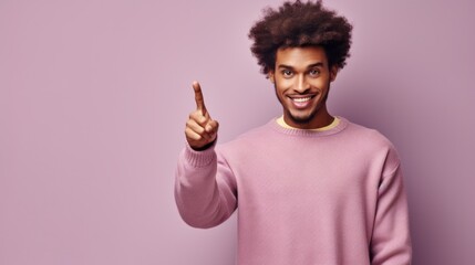 A man in a pink sweater pointing at the camera. Suitable for various projects - obrazy, fototapety, plakaty