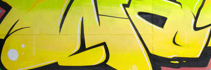 Colorful background of graffiti painting artwork with bright aerosol outlines on wall. Old school...