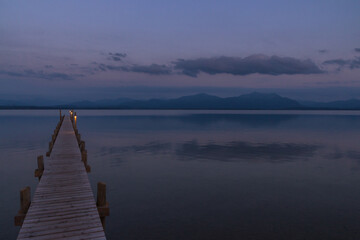 Fototapeta premium Wooden pier leaks into the lake chiemsee