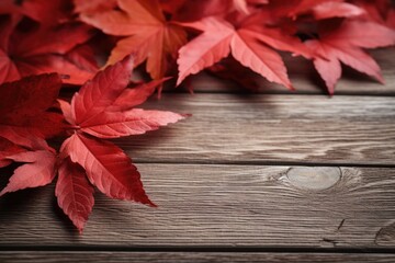 Naklejka na ściany i meble Red leaves on wooden table, perfect for autumn-themed designs