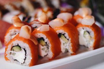 Beautifully decorated catering banquet table with different food snacks and appetizers with sandwich, caviar, fresh fruits on corporate christmas birthday party event or wedding celebration.