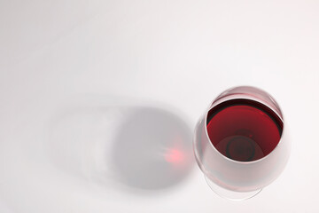 Tasty red wine in glass isolated on white, above view