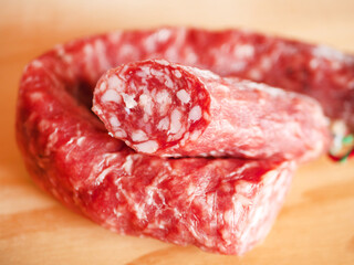 Sliced Genoa Salami on Wooden Background