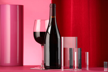 Stylish presentation of delicious red wine in bottle and glass on color background