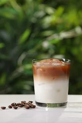 Foto op Plexiglas Glass of iced coffee and beans on white wooden table outdoors. Space for text © New Africa