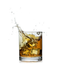 Whiskey splashing out of glass on white background