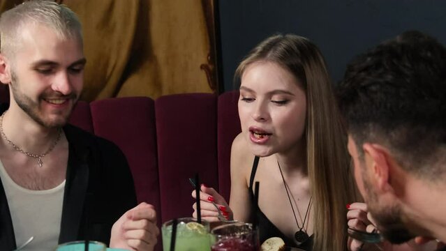 Man lets woman taste dish during party in restaurant. Lady taste buds tantalized by exquisite combination of flavors and textures