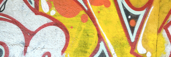 Colorful background of graffiti painting artwork with bright aerosol outlines on wall. Old school...