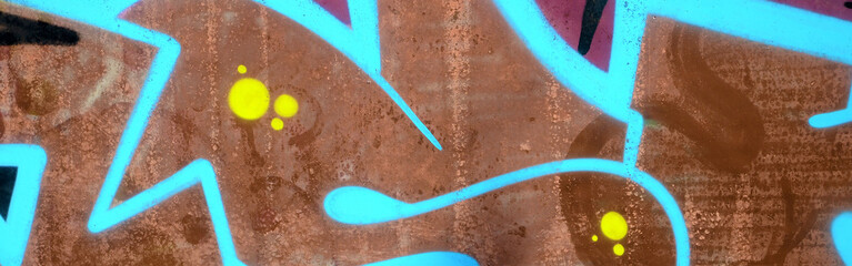 Colorful background of graffiti painting artwork with bright aerosol outlines on wall. Old school...
