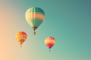 Naklejka premium colorful hot air balloons floating in a clear sky, on a dreamy pastel background, conveying freedom and adventure, with room for text 
