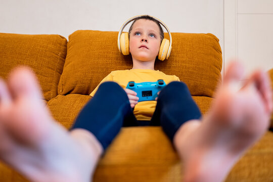 Young boy immersed in video gaming with headphones