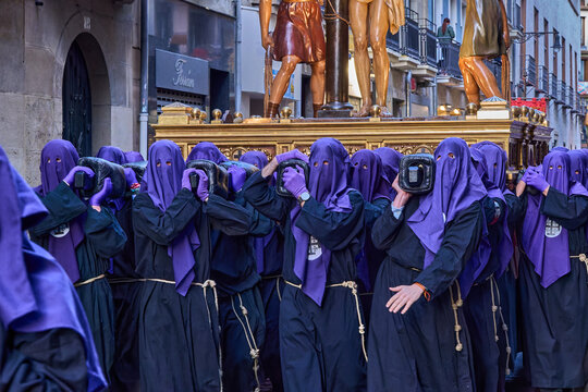 Fototapeta Procession Participants in Purple Robes Carrying Golden Statues