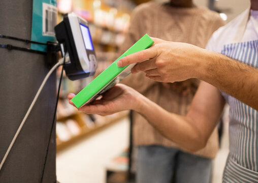 Customer making a payment at a grocery store checkout