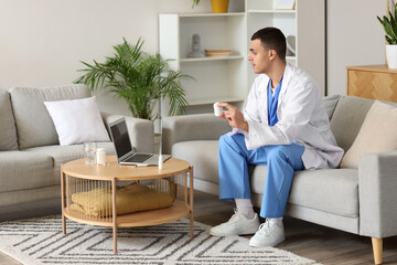 Young doctor showing pills to patient online at home