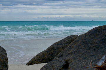 Waves in Miami beach with rocks