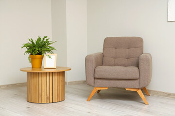 Interior of living room with armchair and wooden table