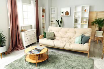 Interior of cozy living room with sofa, table and drawers