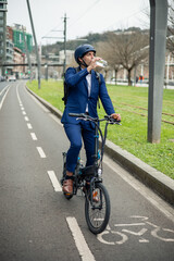 vertical portrait Businessman Refreshing with Water Bottle by Electric Bike on Bike Lane
