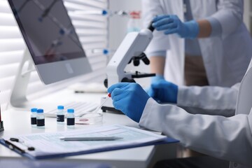 Scientists working with samples in laboratory, closeup. Medical research