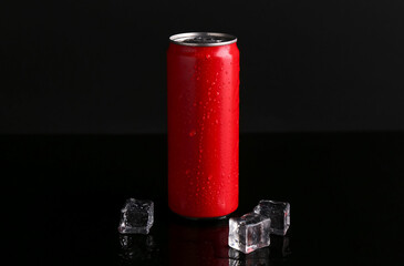 Energy drink in wet can and ice cubes on black background