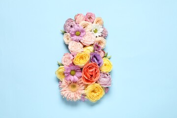 8 March greeting card design made with beautiful flowers on light blue background, top view