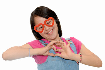 Portrait of a girl with down syndrome. Forming a heart with her hands.