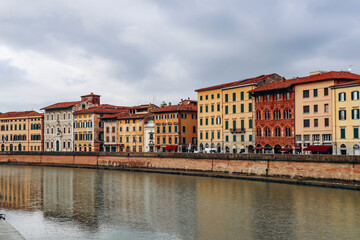 Fototapeta na wymiar Embankments of the Arno River in the center of Pisa, in Tuscany, central Italy
