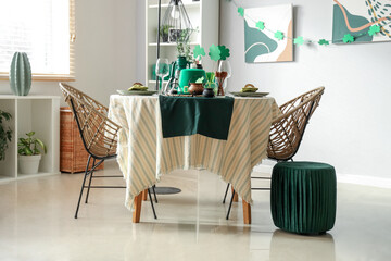 Festive table serving with leprechaun's hat and decorations for St. Patrick's Day celebration in...