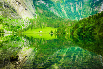 Reflection of the surrounding mountains in lake Obersee near Koenigssee, Berchtesgaden, Bavaria,...
