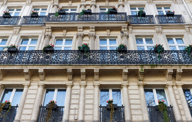 The facade of traditional French house with typical balconies and windows. Paris. - 752600249