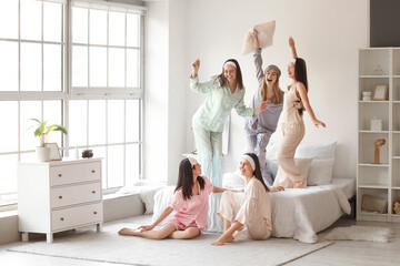 Young women dancing at Hen Party in bedroom