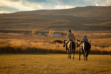 Father and Daughter Cowboy cowgirl riding horses
