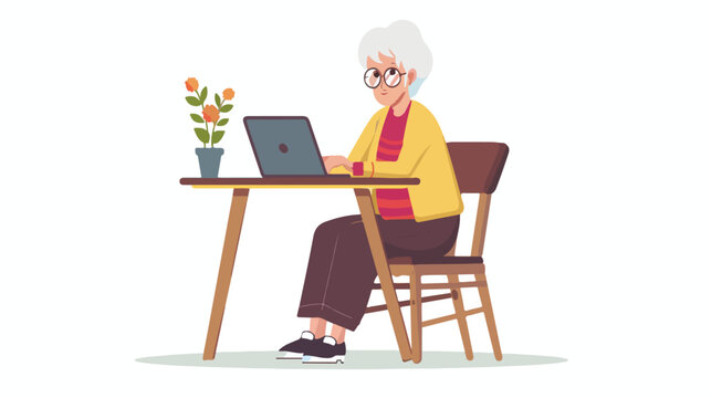 Elderly Woman Sitting At Table And Working With laptop