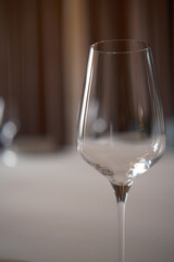 close up empty glasses for wine, light restaurant interior on background